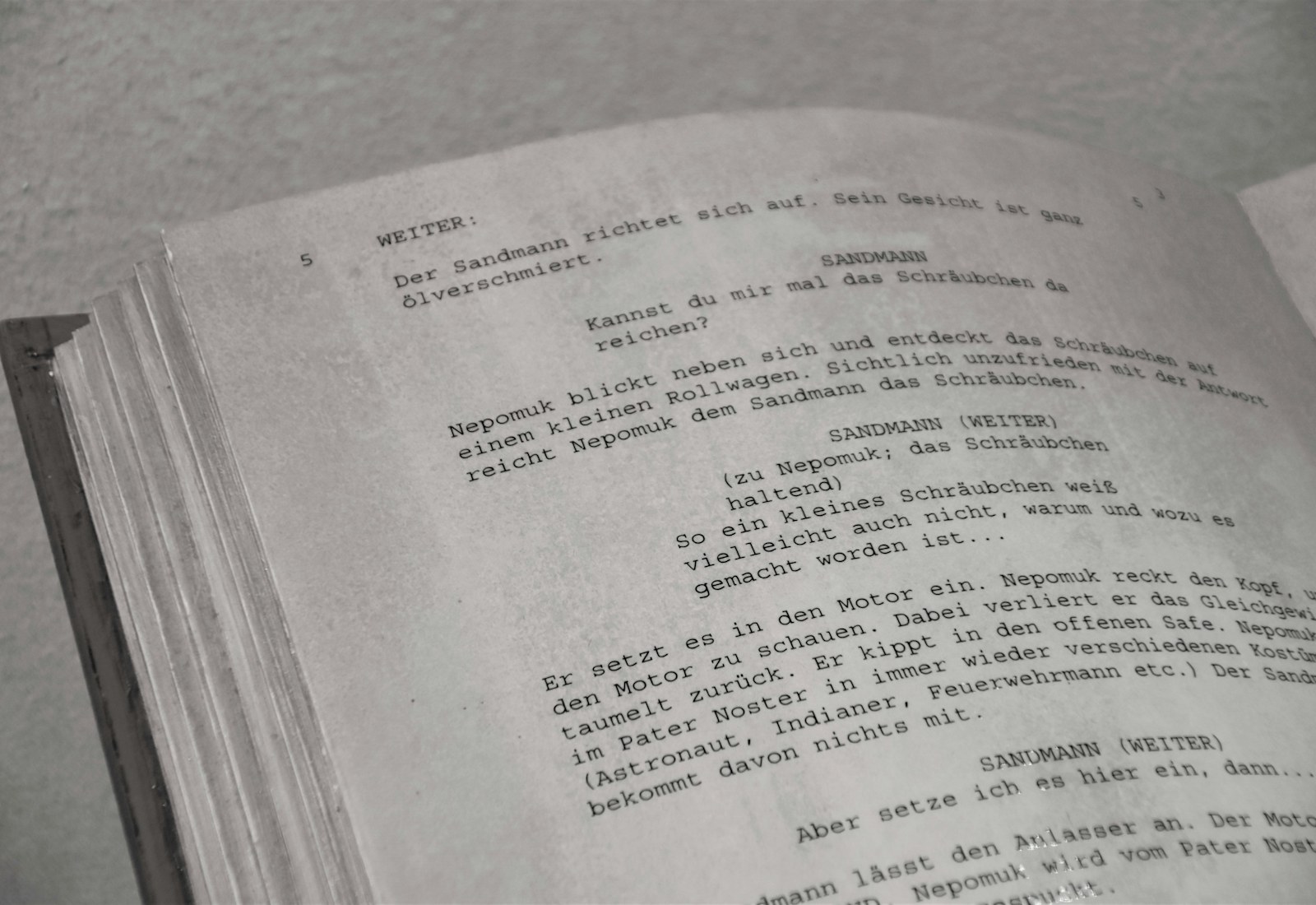 Bound paper film script open on a desk, representing static documentation that can’t keep up with production changes